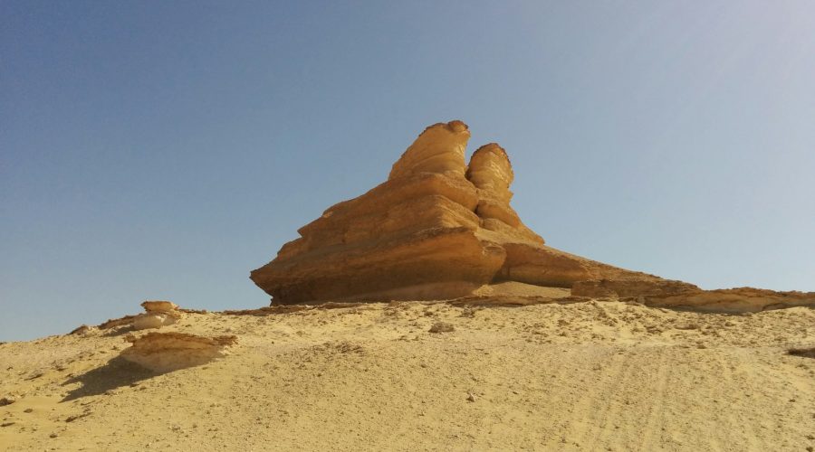 Standalone rock in the Wadi El Rayan desert on a three-day Fayoum camping tour