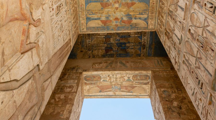 Hieroglyph reliefs on a giant doorway at Medinet Habu on a Valley of the Queens tour in Luxor
