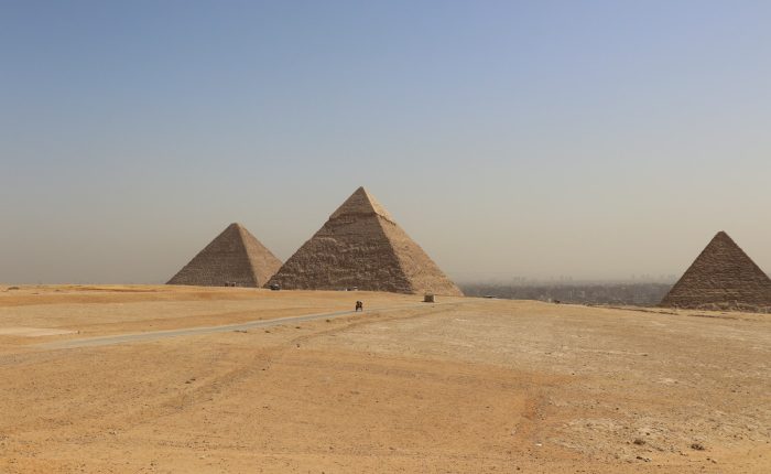 The Giza pyramids with the Cairo skyline behind on the Cairo day trip from Aswan by flight