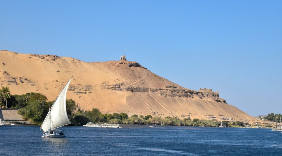 Felucca on the Nile in front of the Tombs of the Nobles on Aswan's west bank
