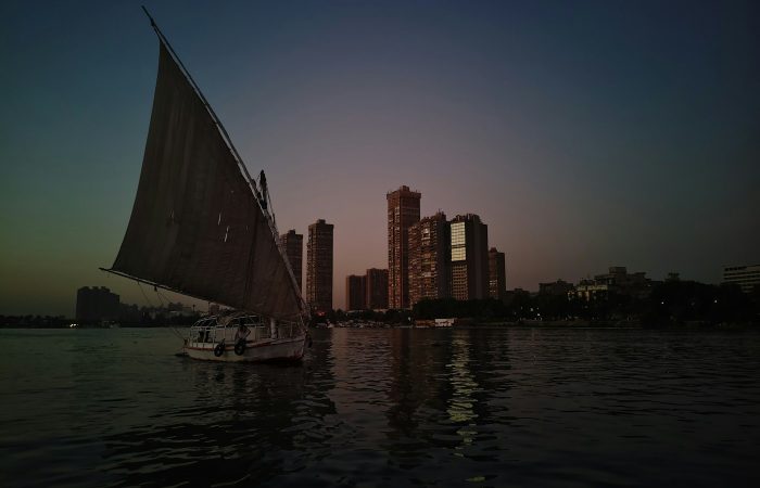 Felucca sailing on the Nile with the Cairo skyline at dusk on a Cairo by night tour