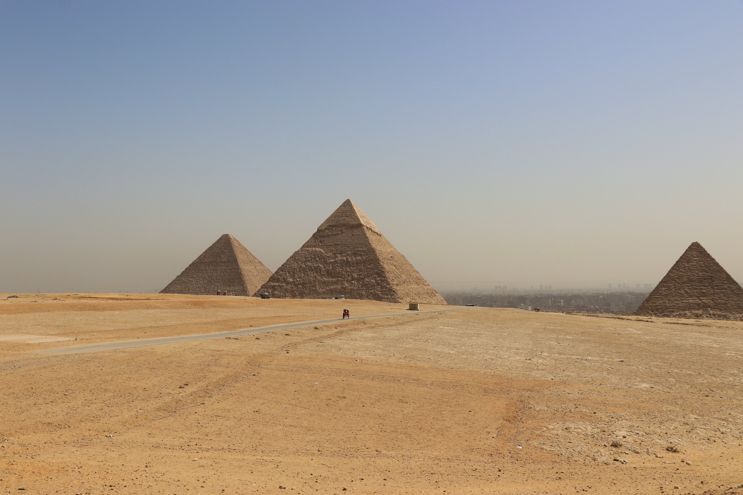 Wide view of the Pyramids of Giza on the edge of the desert, the first stop on an 8-day classic Egypt tour
